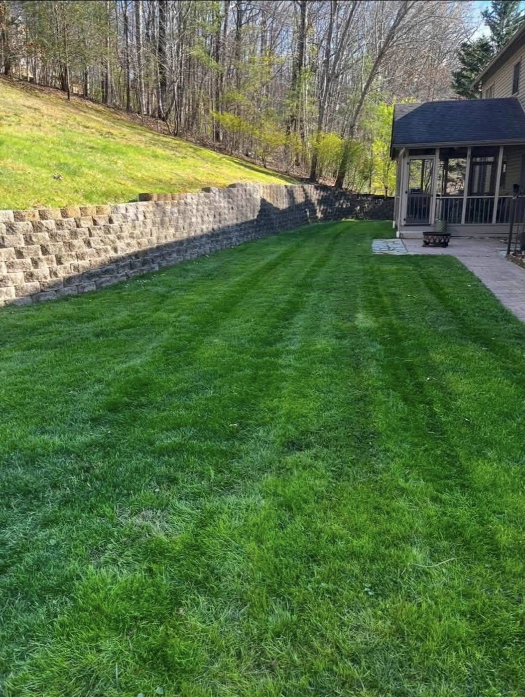 Retaining wall and striped lawn built by Bulldog Land Management